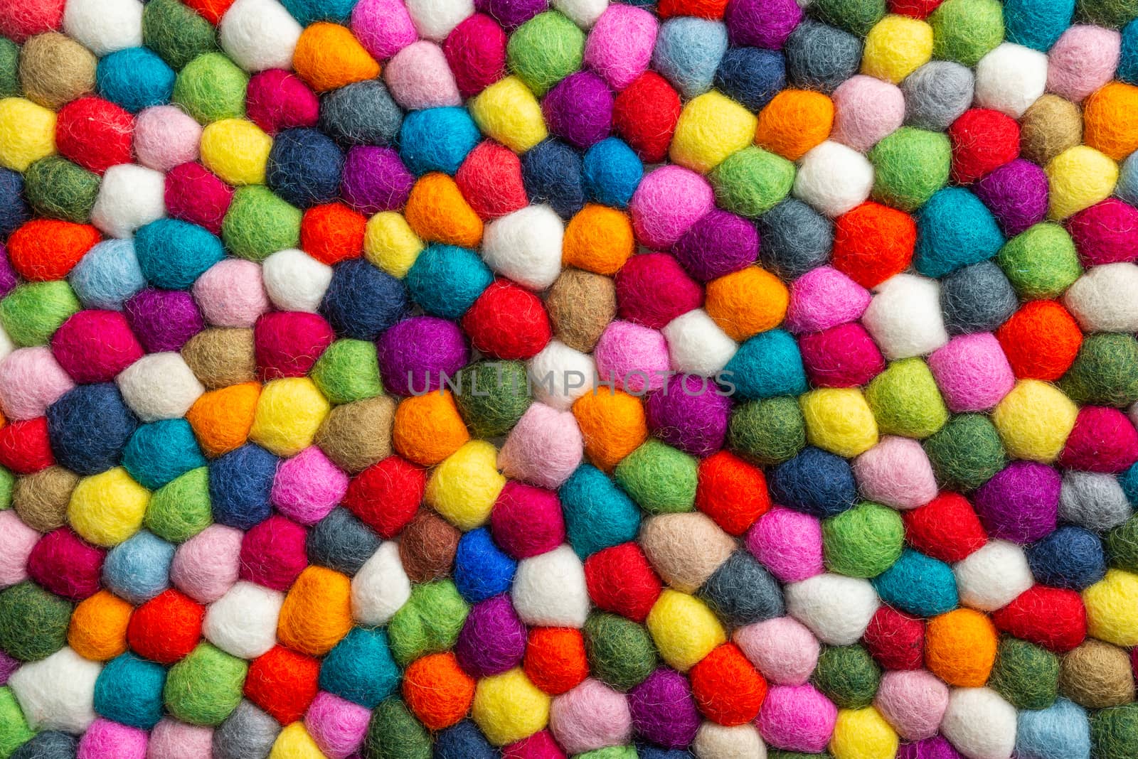 Multicolored felt ball rug detail, colorful texture