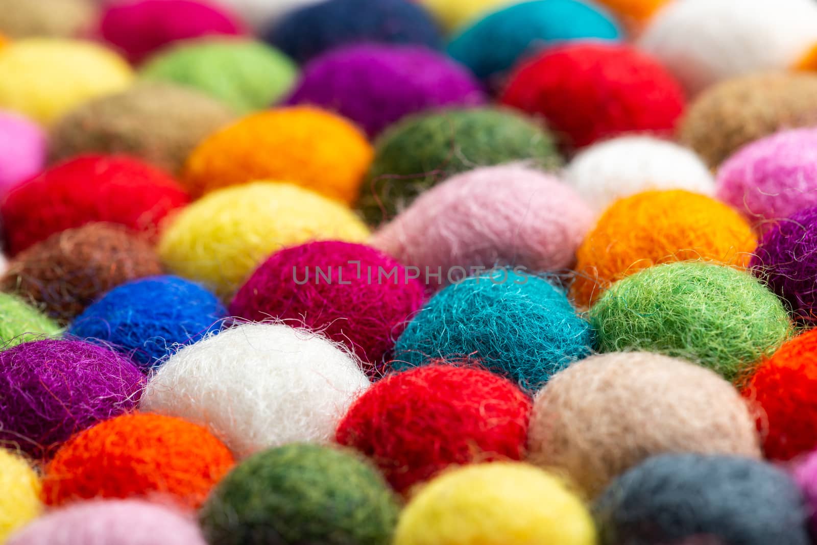 Multicolored felt ball rug detail, colorful texture