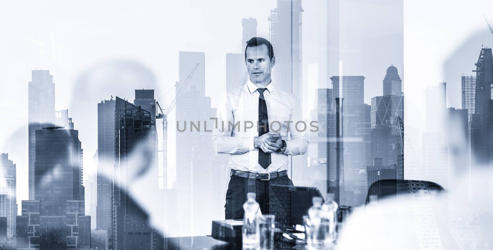 Corporate business, economic development or real estate company concept. Confident company leader on business meeting against new york city manhattan buildings and skyscrapers window reflections.