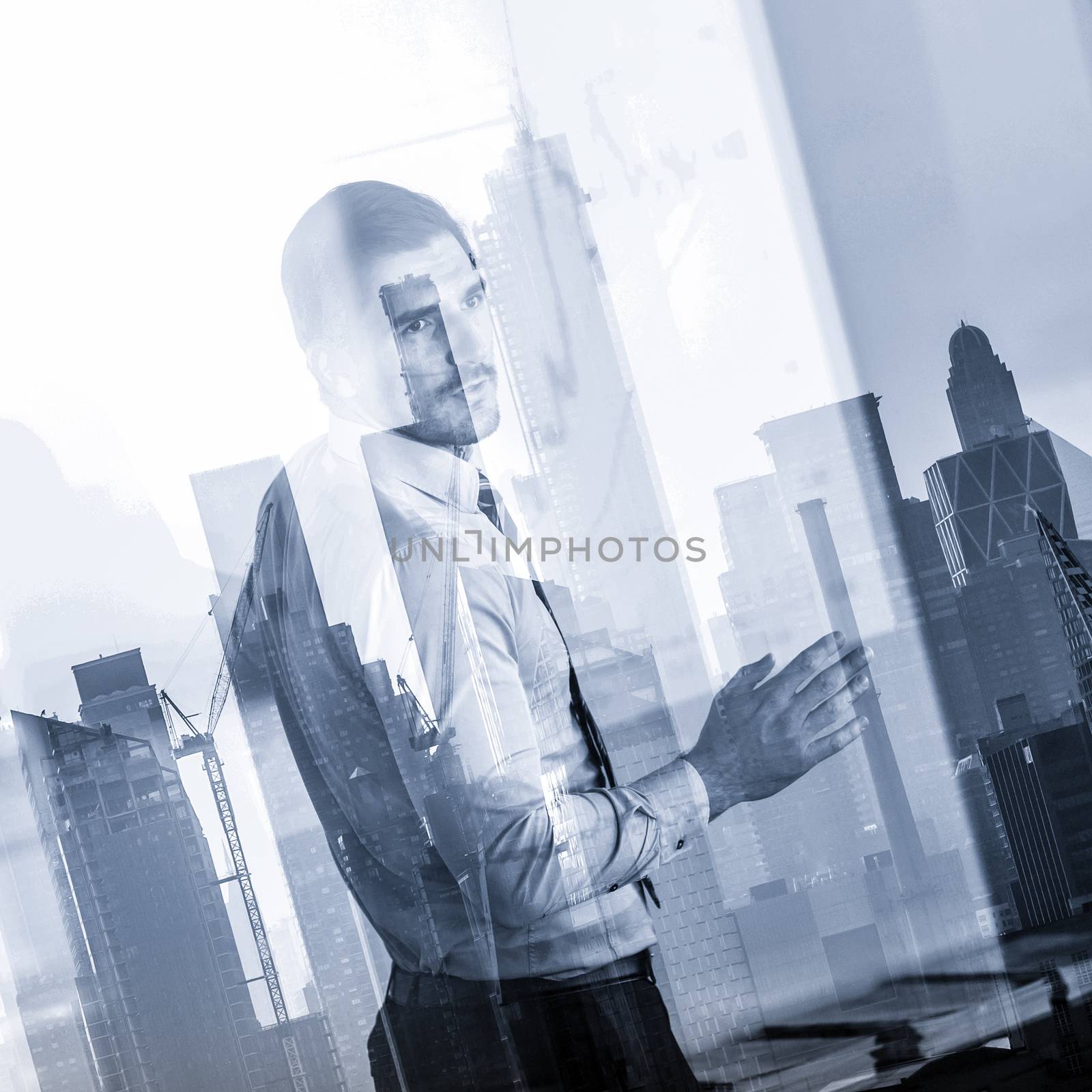 Business man making presentation in corporate office. Business executive delivering a presentation during business meeting against new york city manhattan buildings and skyscrapers window reflection.