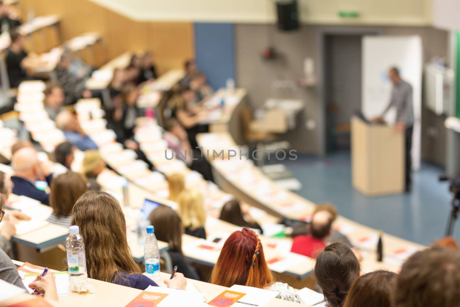 Conference and Presentation. Audience at the conference hall. Business and Entrepreneurship. Faculty lecture and workshop. Audience in the lecture hall. Academic education. Participants making notes.