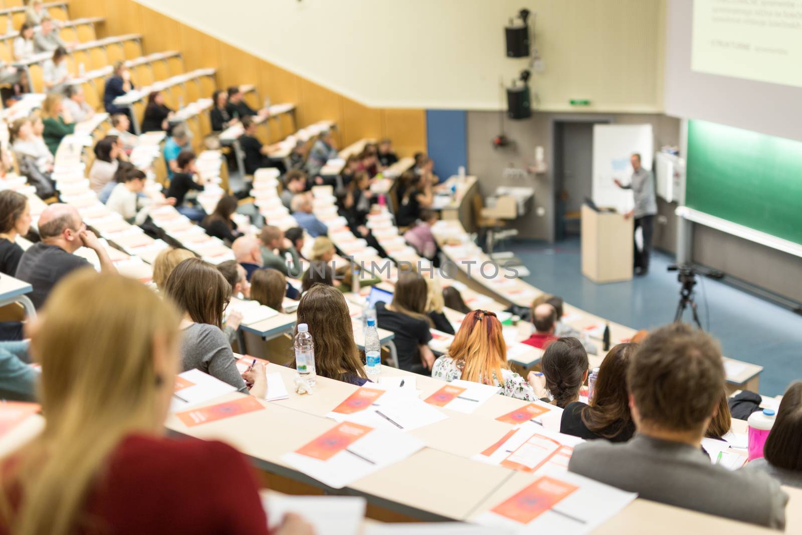 Conference and Presentation. Audience at the conference hall. Business and Entrepreneurship. Faculty lecture and workshop. Audience in the lecture hall. Academic education. Student making notes.