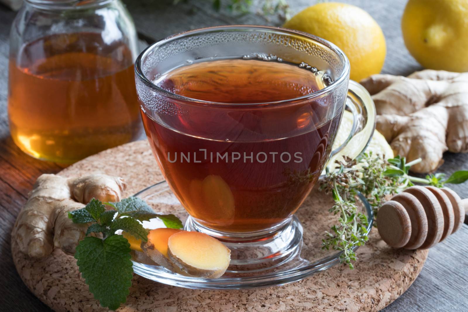 A cup of tea with ginger, lemon, herbs and honey by madeleine_steinbach
