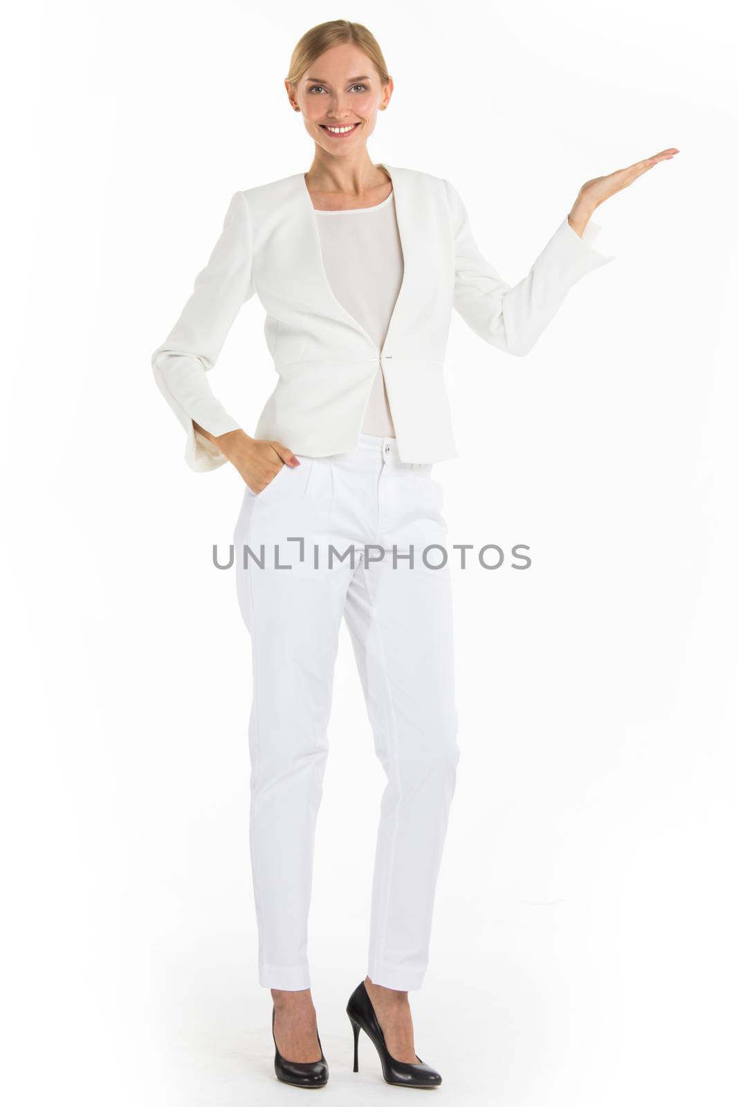Businesswoman pointing with hand palm at empty copy space, studio isolated on white background, full length portrait