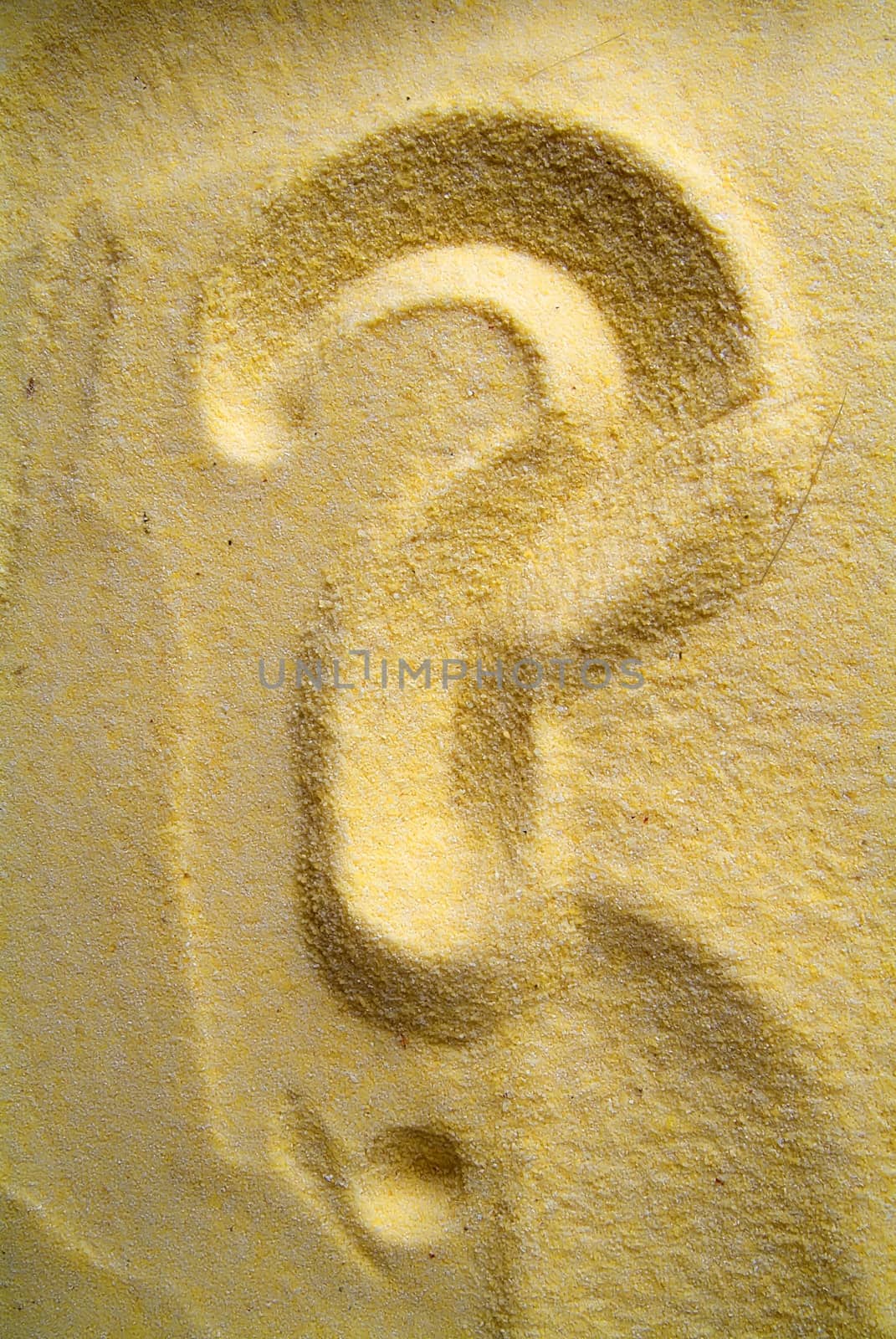 question mark sign handwritten in yellow sand beach