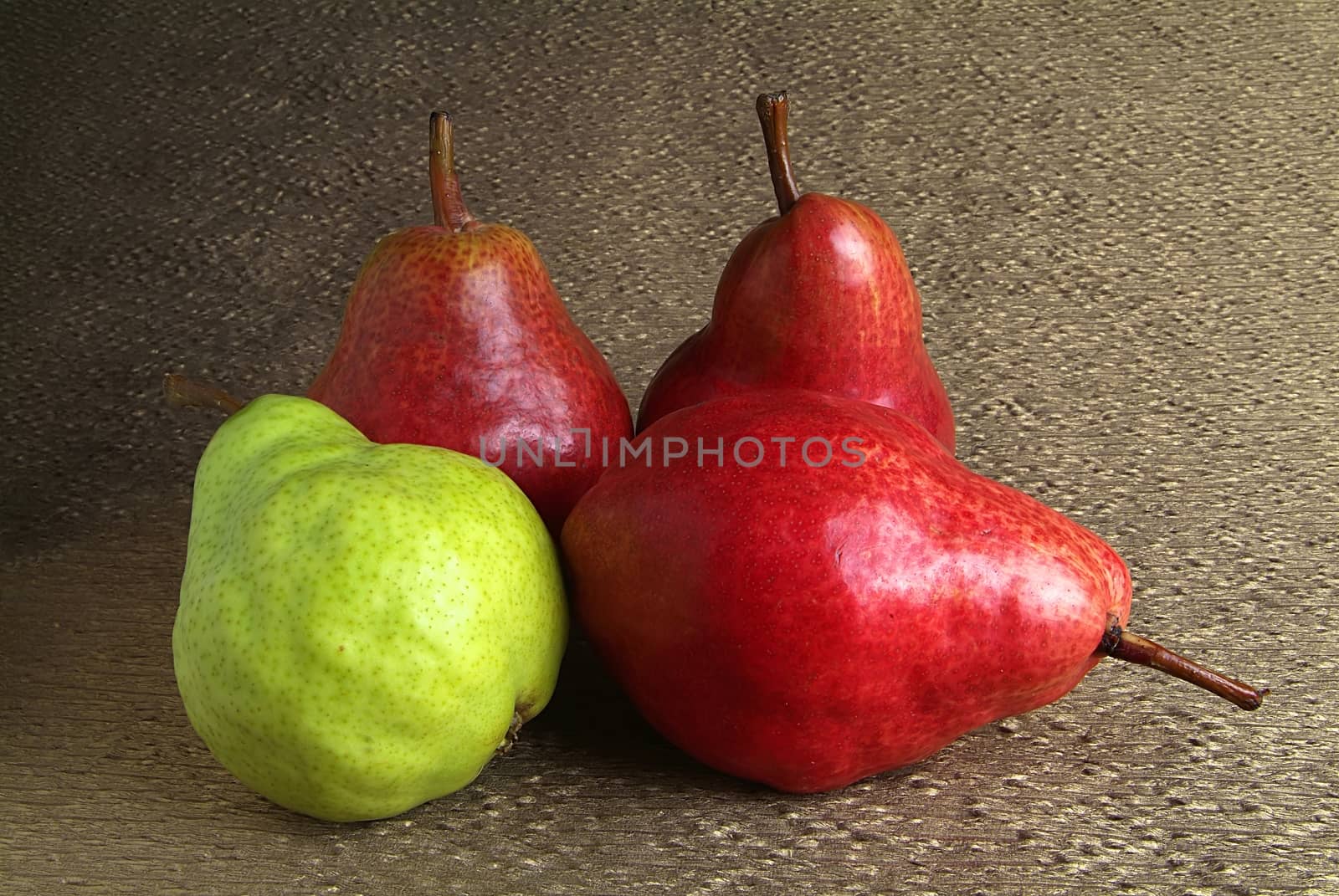 pears and apples on wooden table. by romeocharly