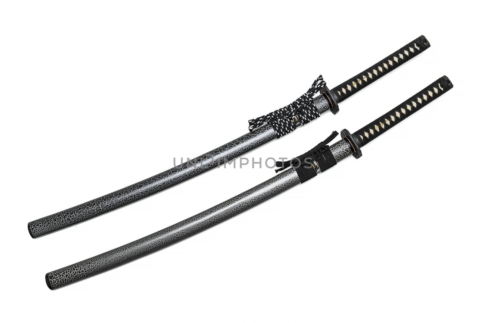 2 Japanese swords and scabbard with black and two-tone cord isolated in white background.