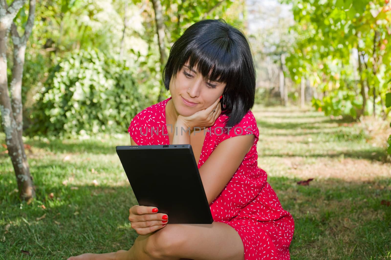 casual woman working with a tablet pc, outdoor