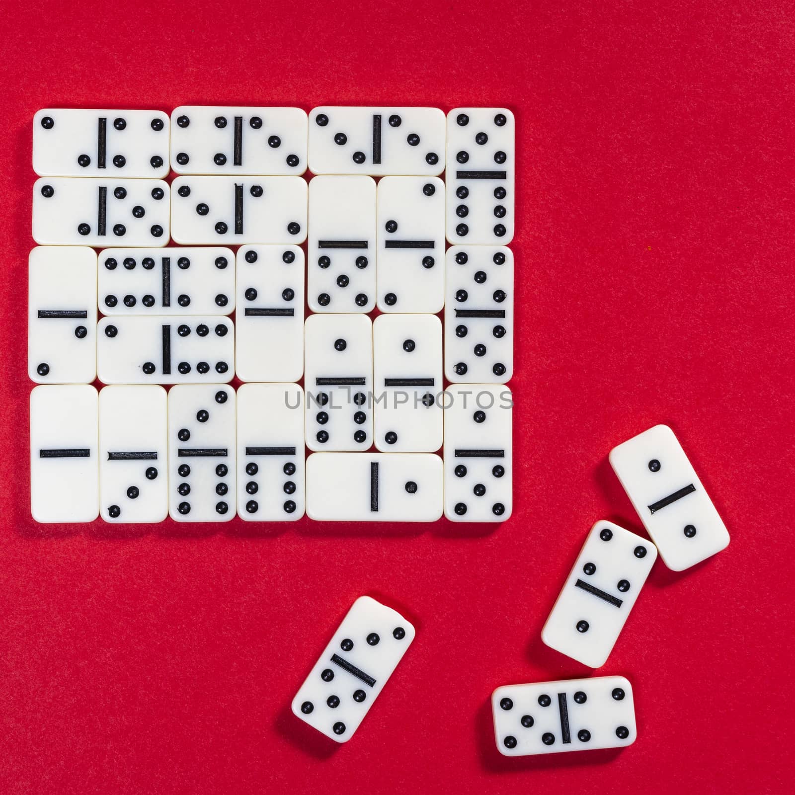 the domino game pieces on a red colored surface