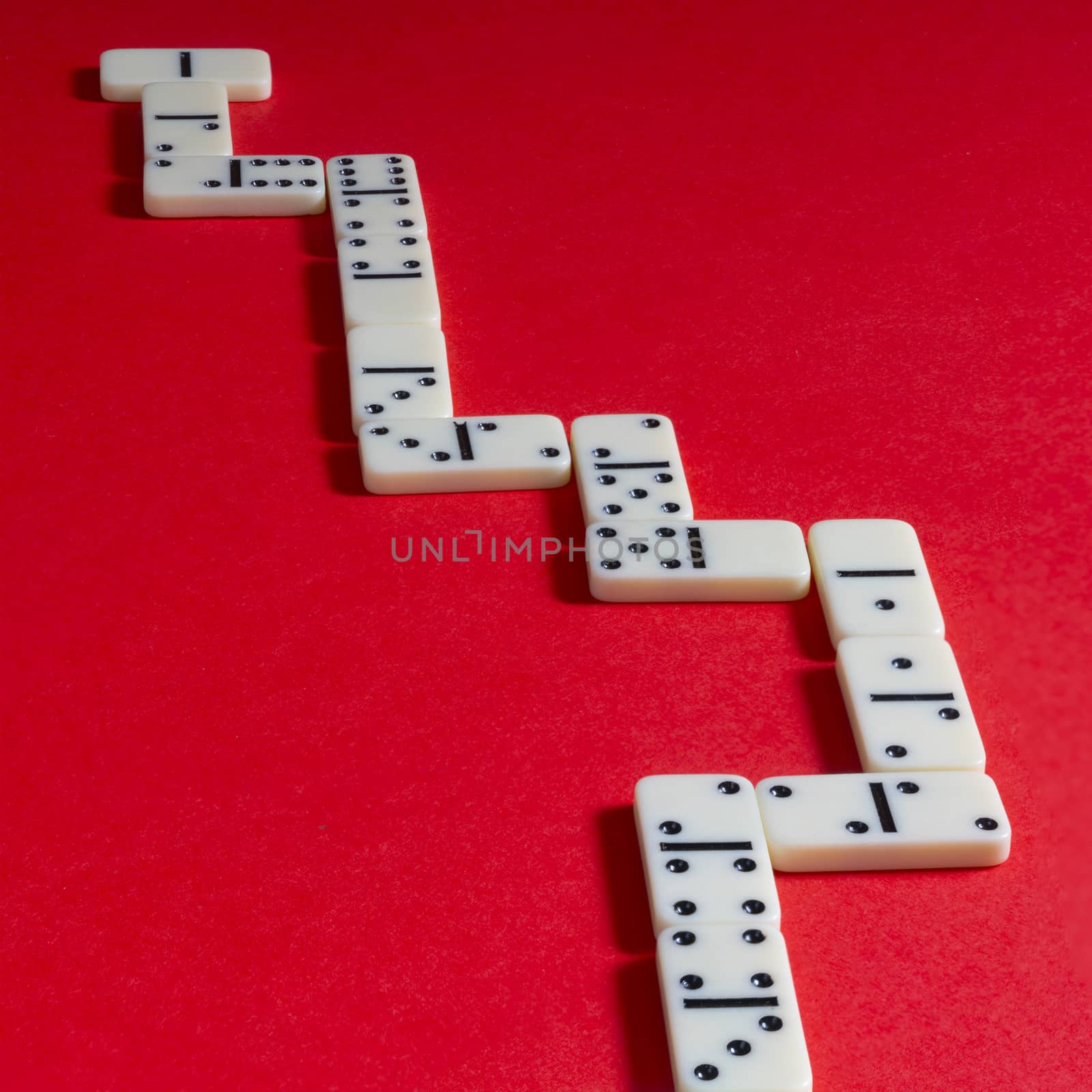 the domino game pieces on a red colored surface