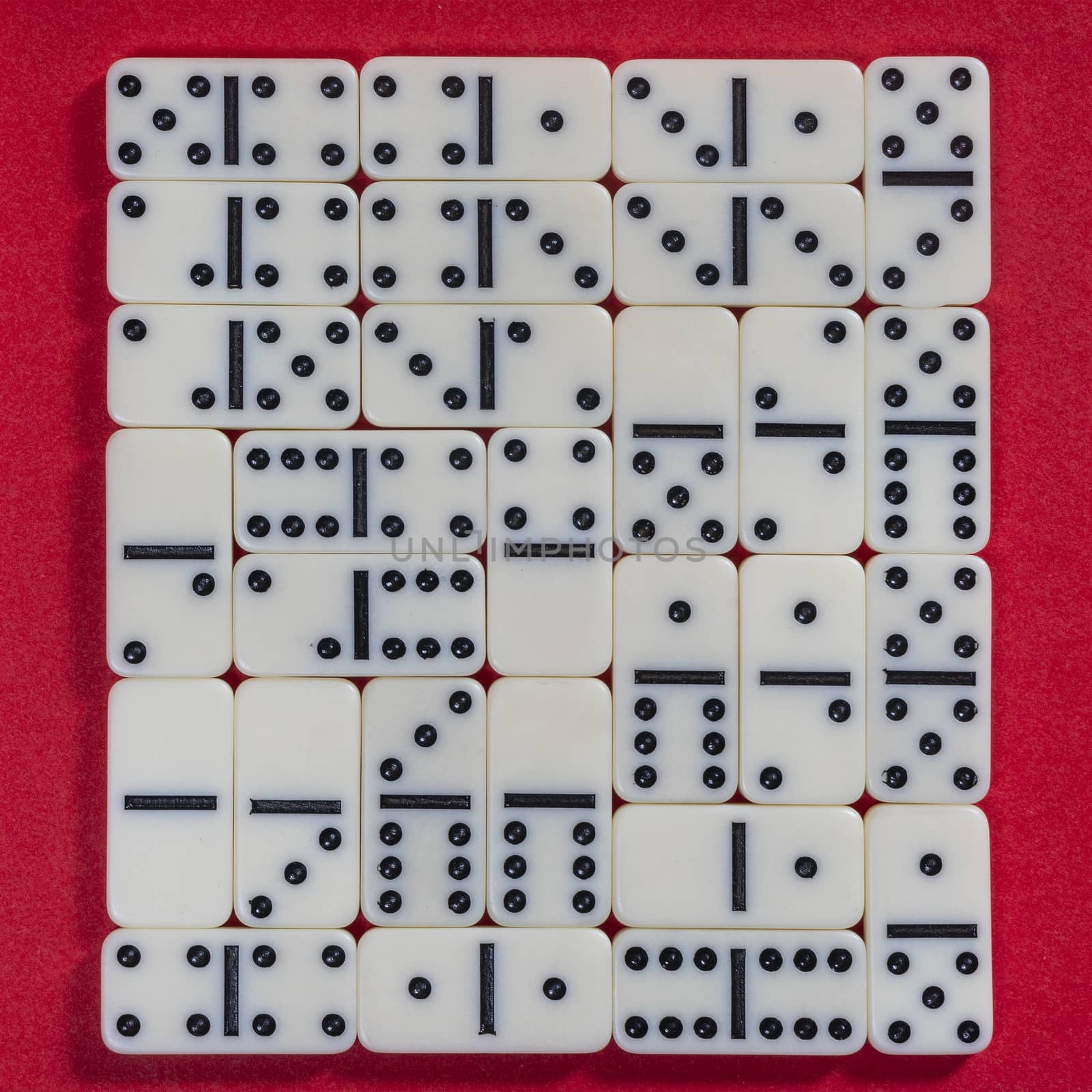 the domino game pieces on a red colored surface