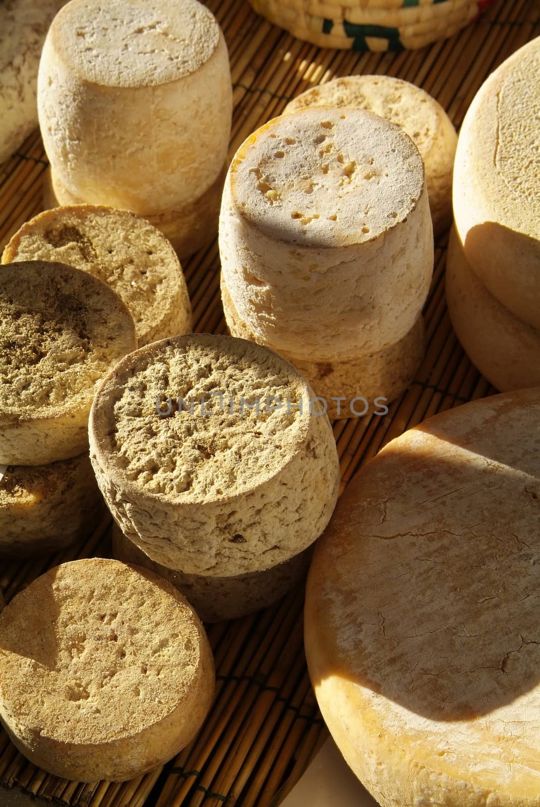 Forms with freshly made cheese on wooden table by romeocharly