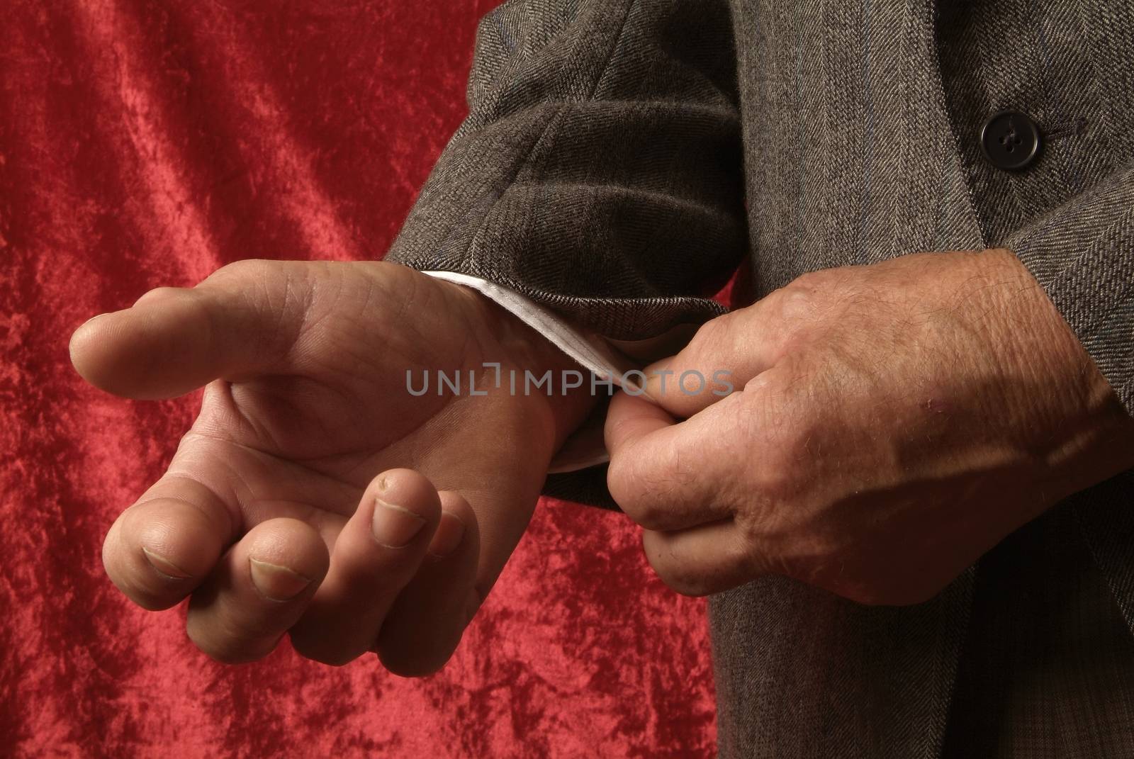 Men hands position to something on darck background, in italy