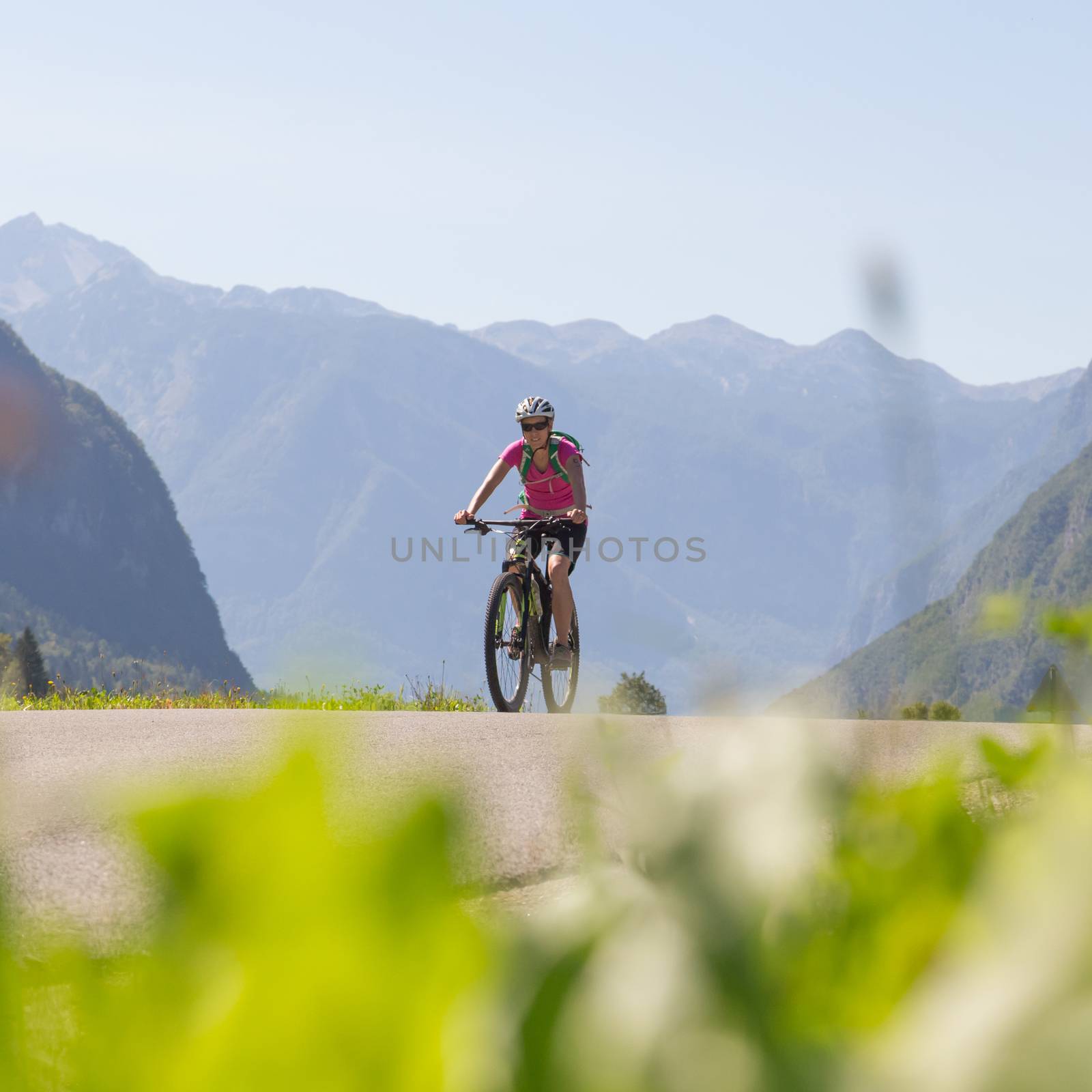 Active sporty woman riding mountain bike in nature. by kasto