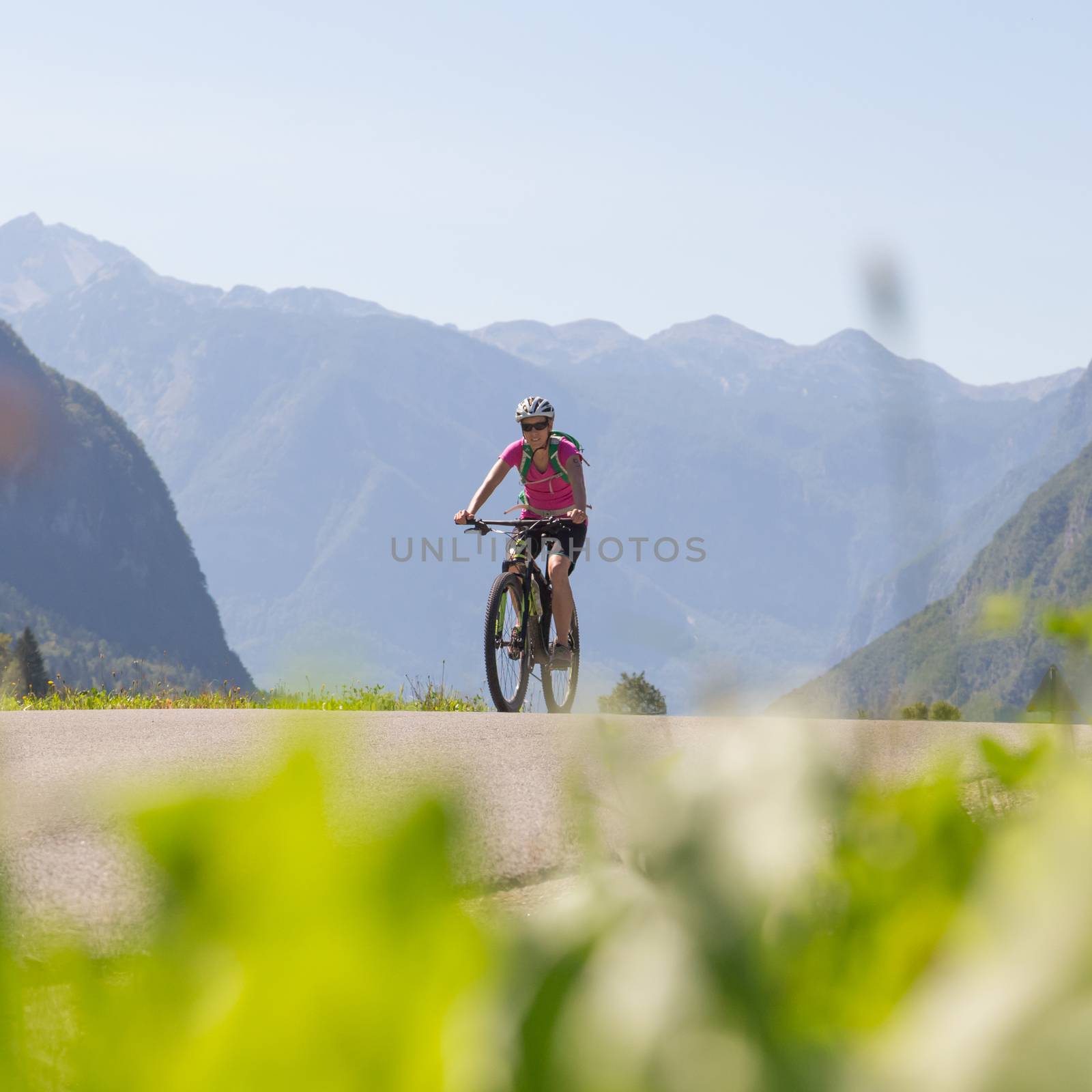 Active sporty woman riding mountain bike in the nature, Slovenia.