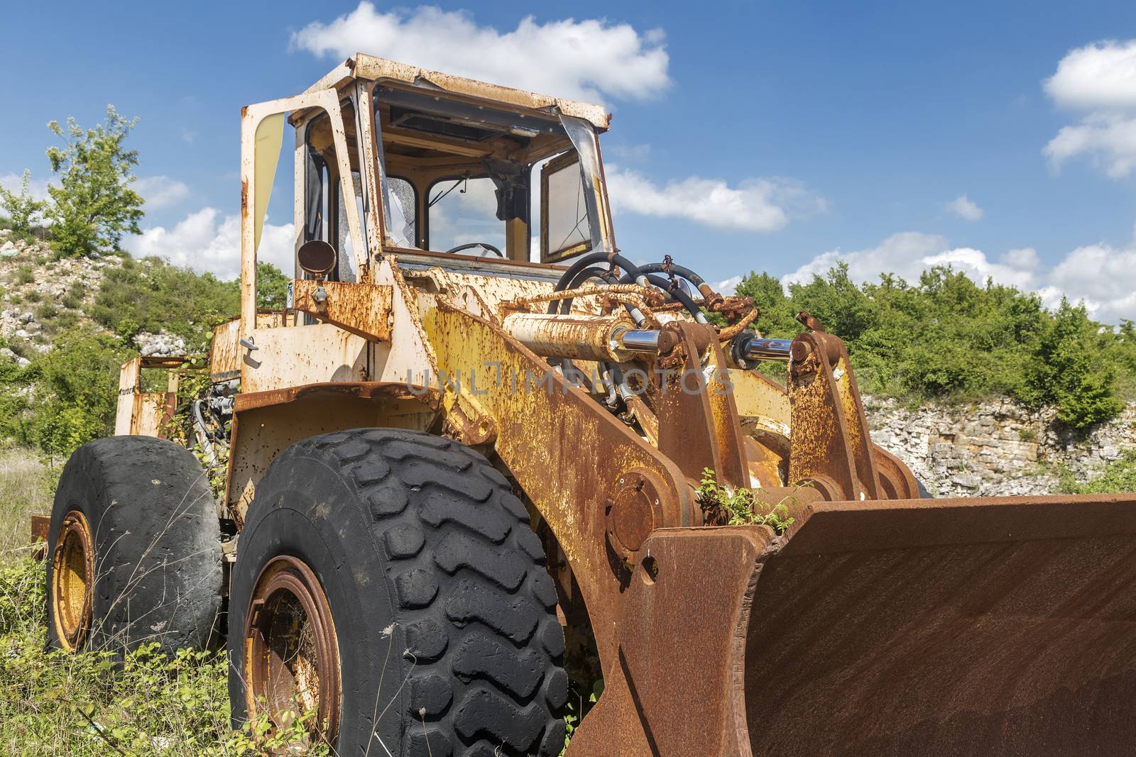 old yellow cracked and abandoned excavator