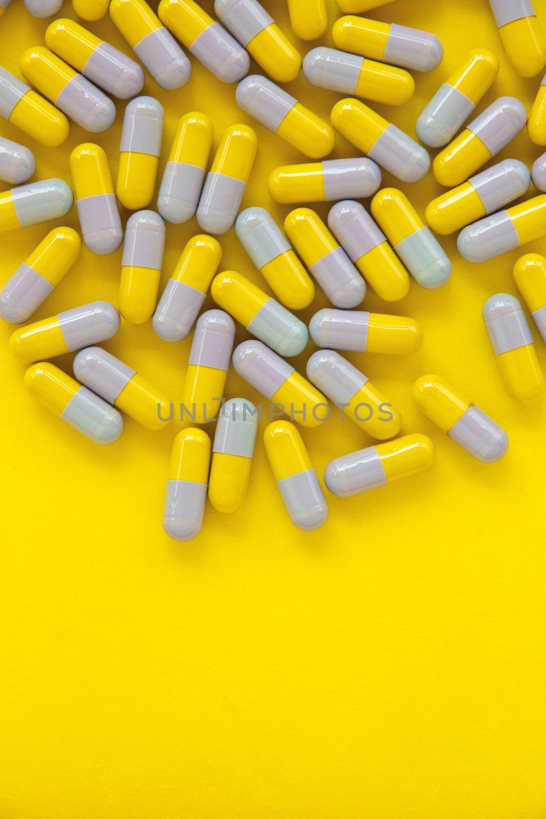 Capsule pills on yellow background