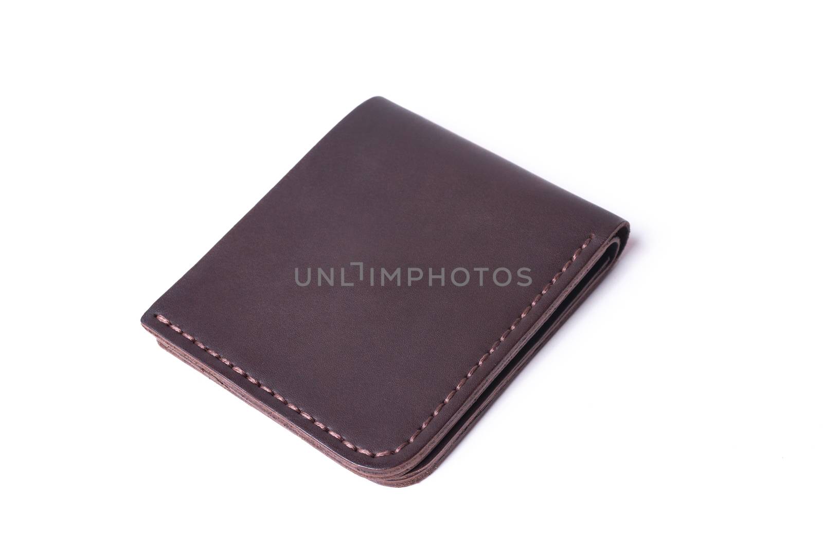 Brown handmade leather man wallet isolated on white background. Wallet is closed. Stock photo of luxury businessman accessories.