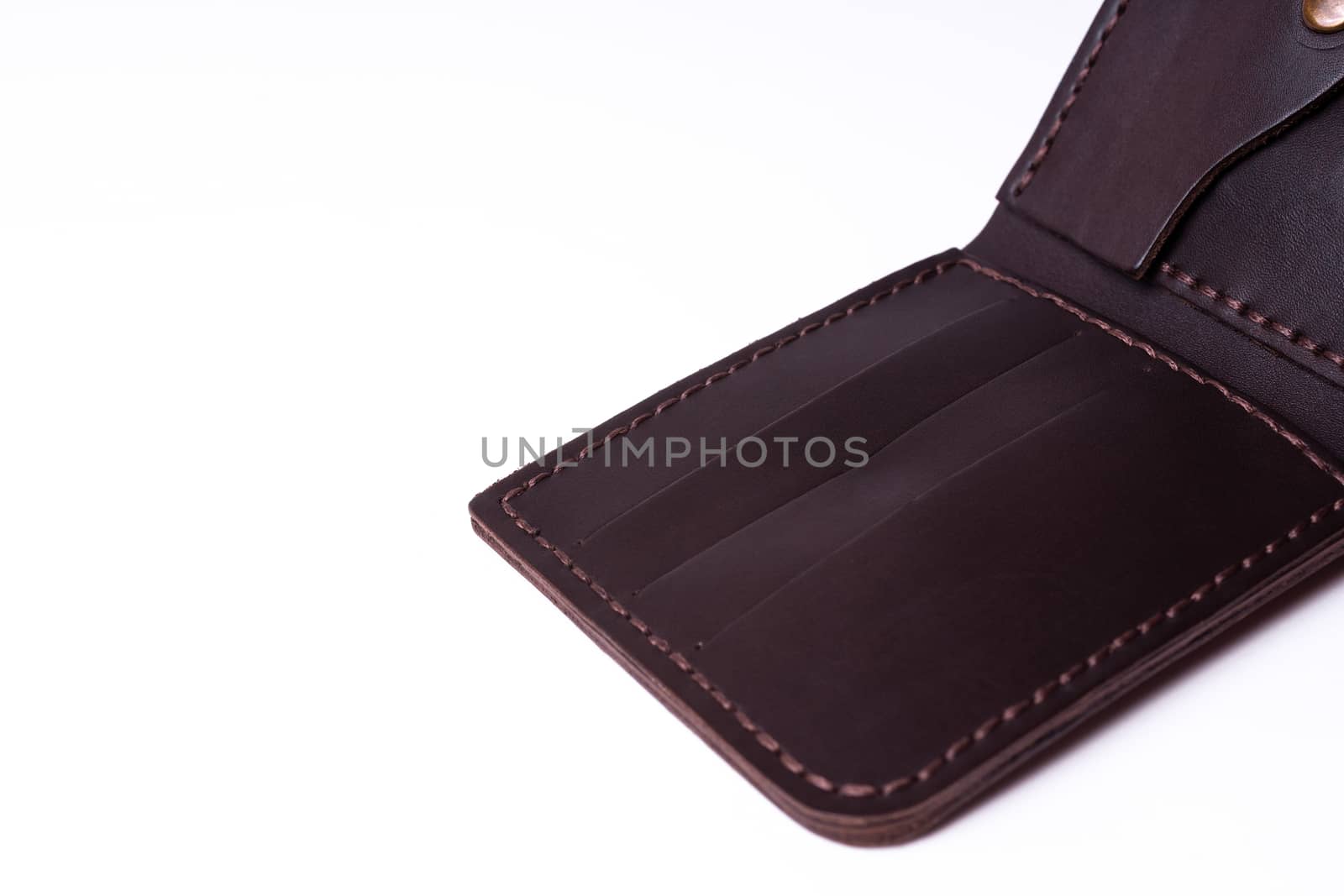 A part of brown handmade leather man wallet isolated on white background. Wallet is open. Stock photo of luxury businessman accessories. by alexsdriver