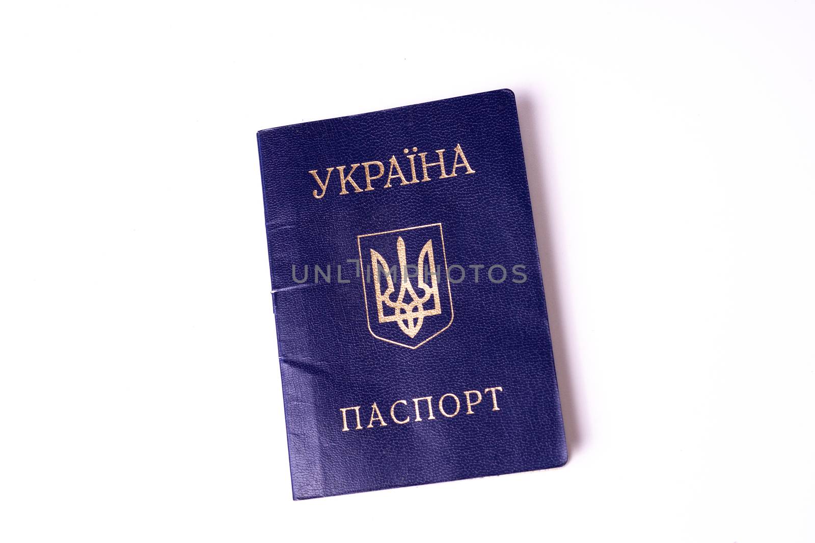 Blue Ukrainian passport isolated on white background. Passport is old and damaged a little bit. Stock photo of travel documents. by alexsdriver