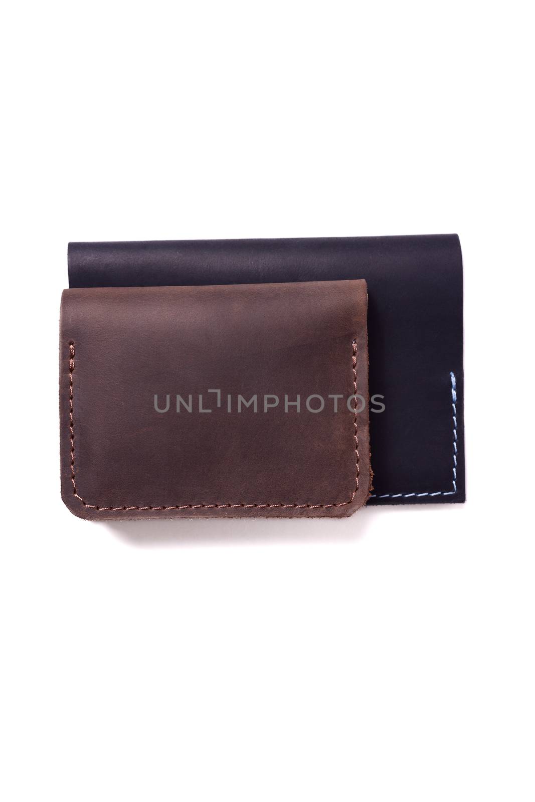 Handmade brown cardholder and black passport cover isolated on white background closeup. Stock photo of handmade luxury accessories. by alexsdriver