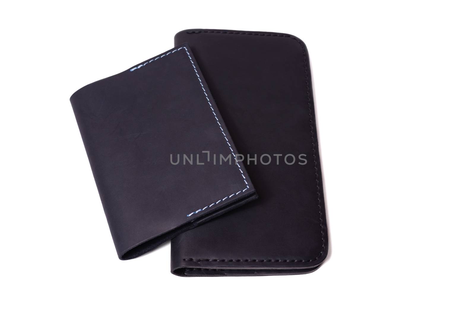 Handmade leather black passport cover and black purse isolated on white background closeup. Stock photo of isolated handmade luxury accessories. by alexsdriver