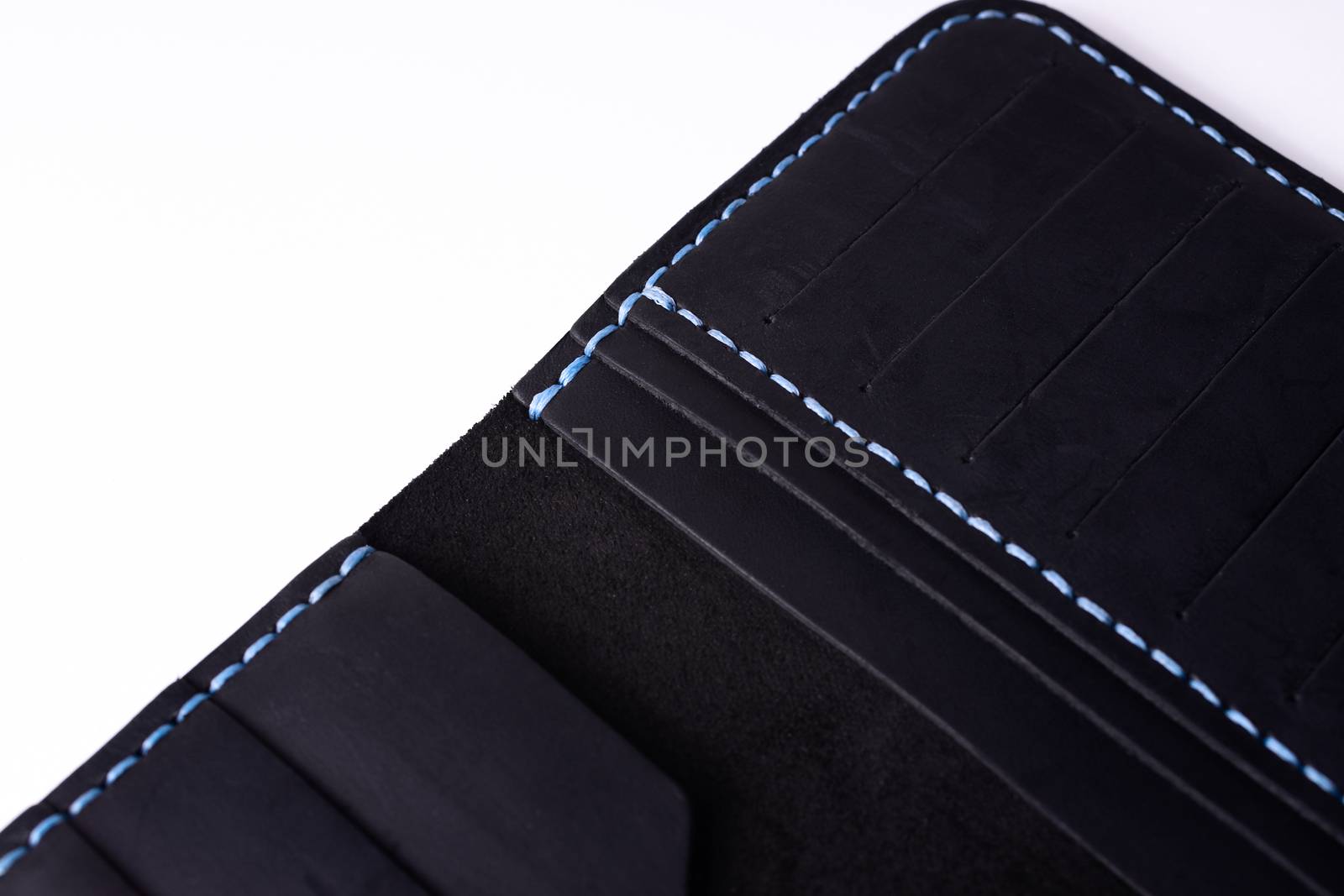 A part of handmade black leather porte-monnaie isolated on white background. Stock photo of luxury accessories. by alexsdriver