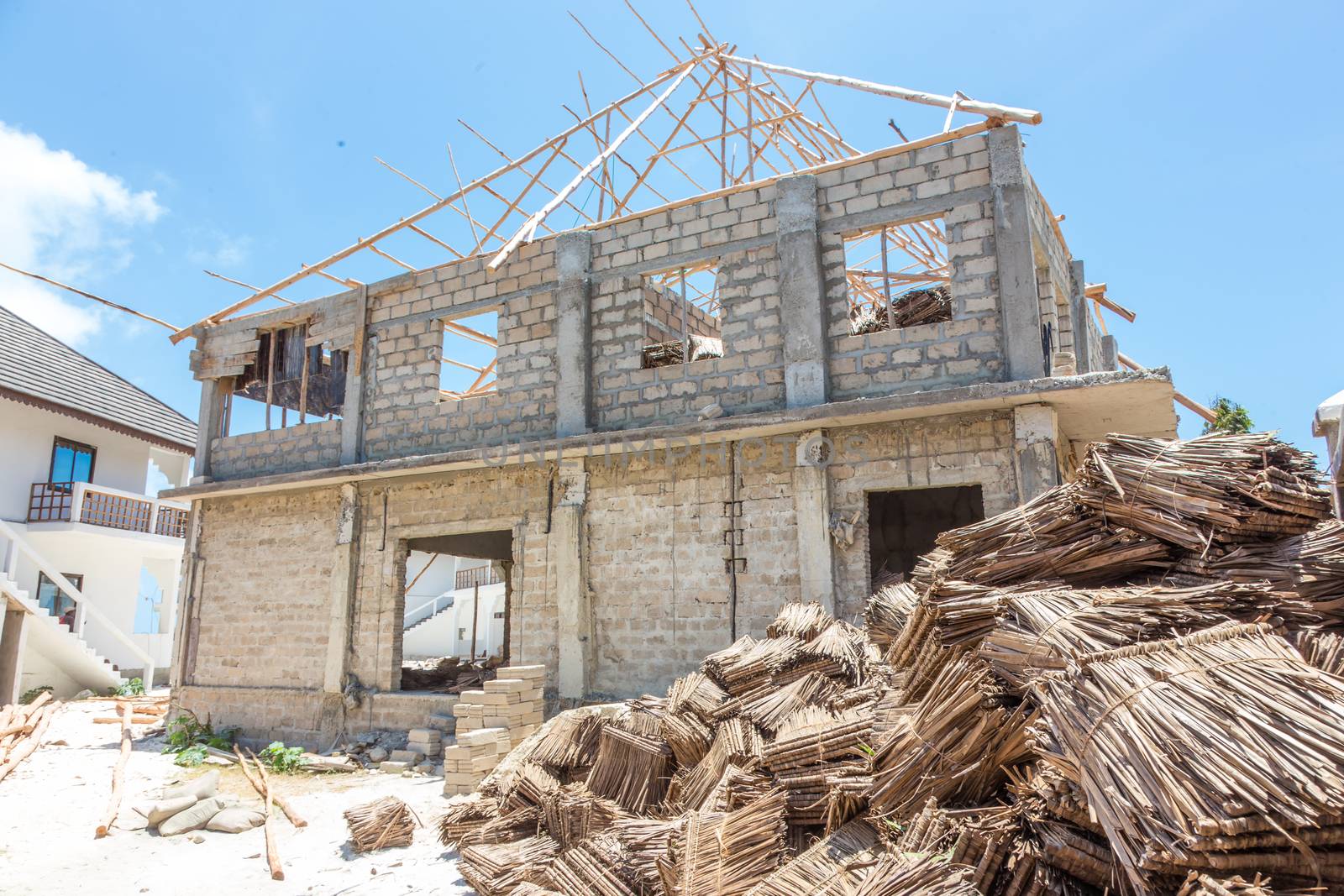 Construction site of traditional roof thatching in Africa. Developing of traditional tached roof civil engineering by kasto