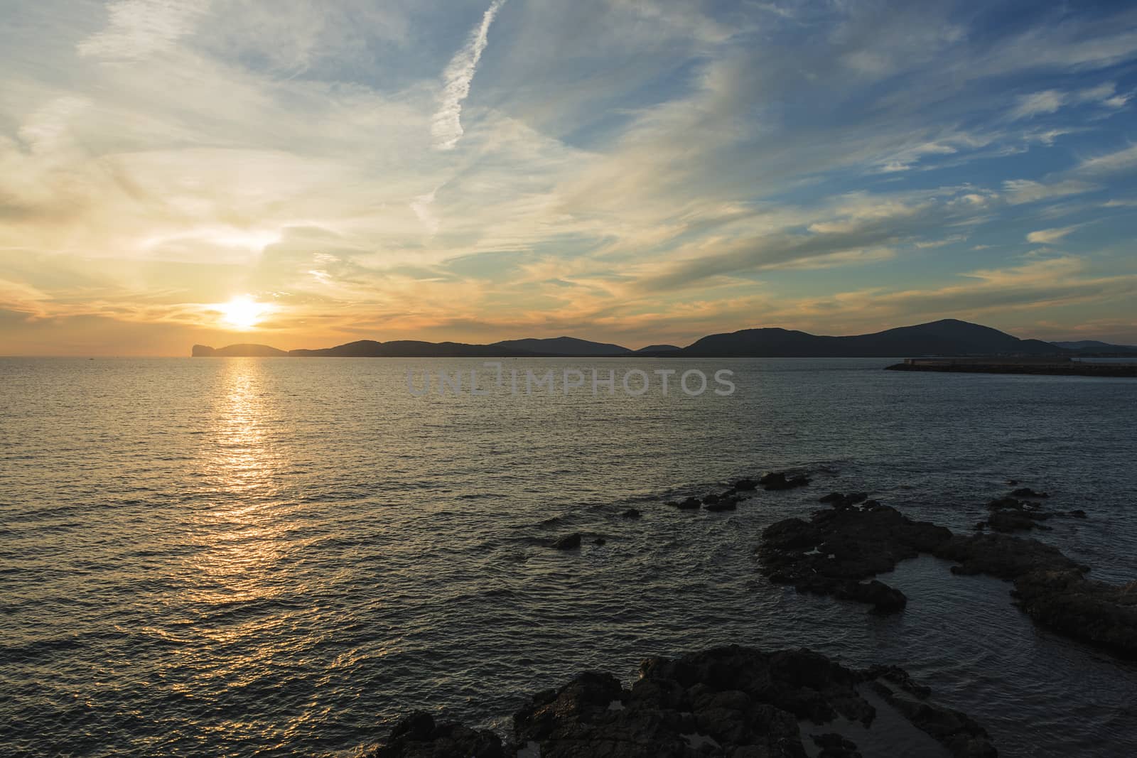 amazing colorful sunset in the Gulf of Alghero, Sardinia, Italy