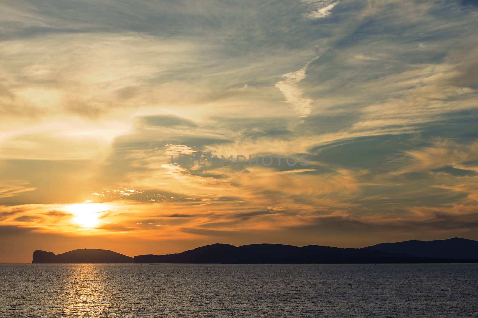 amazing orange sunset on the giant that sleeps in Alghero, Sardinia, Italy