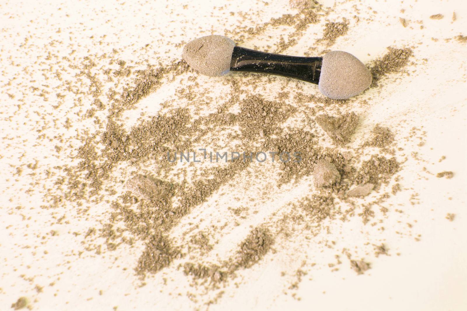 Golden and beige eyeshadow with applicator on white background, beauty and makeup concept.