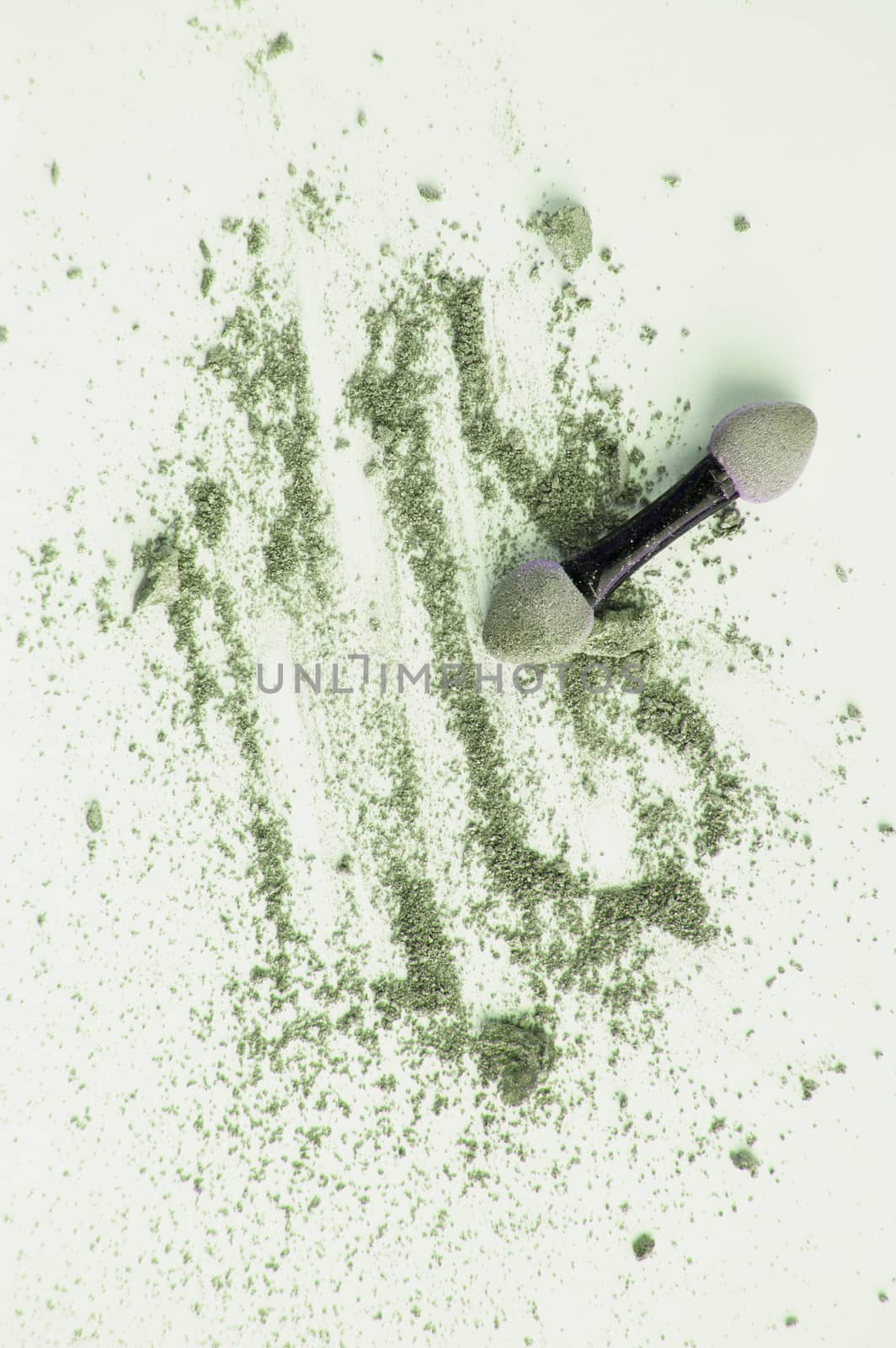 Scattered olive and green eyeshadow with applicator, isolated on white background, beauty and makeup concept, vertical shot by claire_lucia