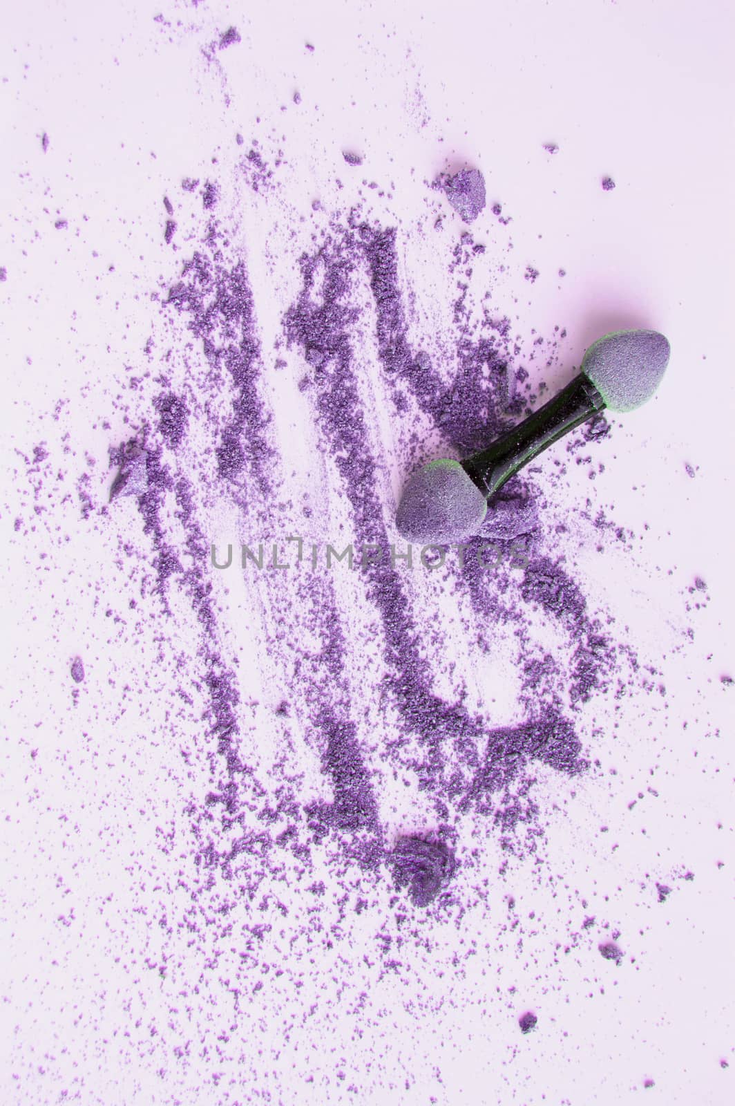 Scattered purple and lilac eyeshadow with applicator, isolated on white background, beauty and makeup concept, vertical shot by claire_lucia