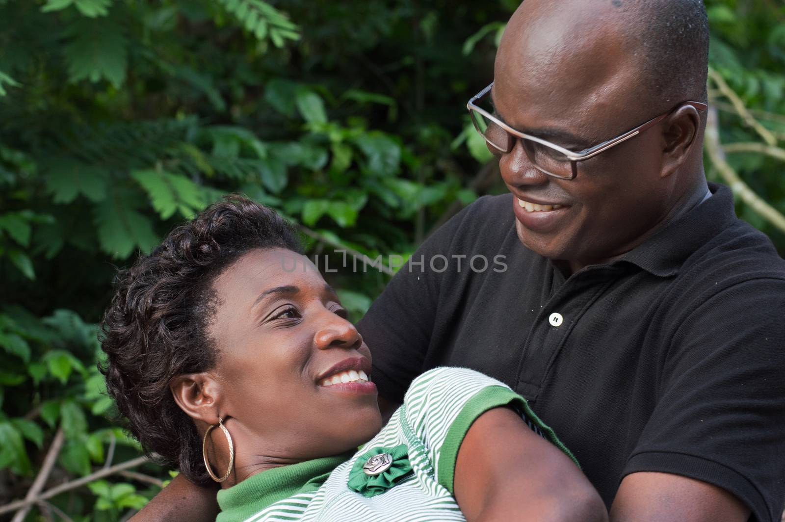 this young woman lying on her husband, looks at him with a beautiful smile