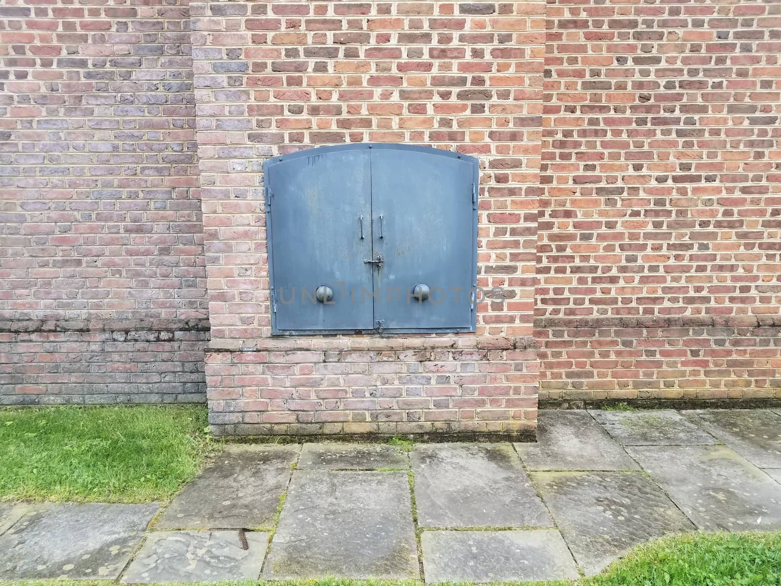 red brick wall or masonry and iron metal door