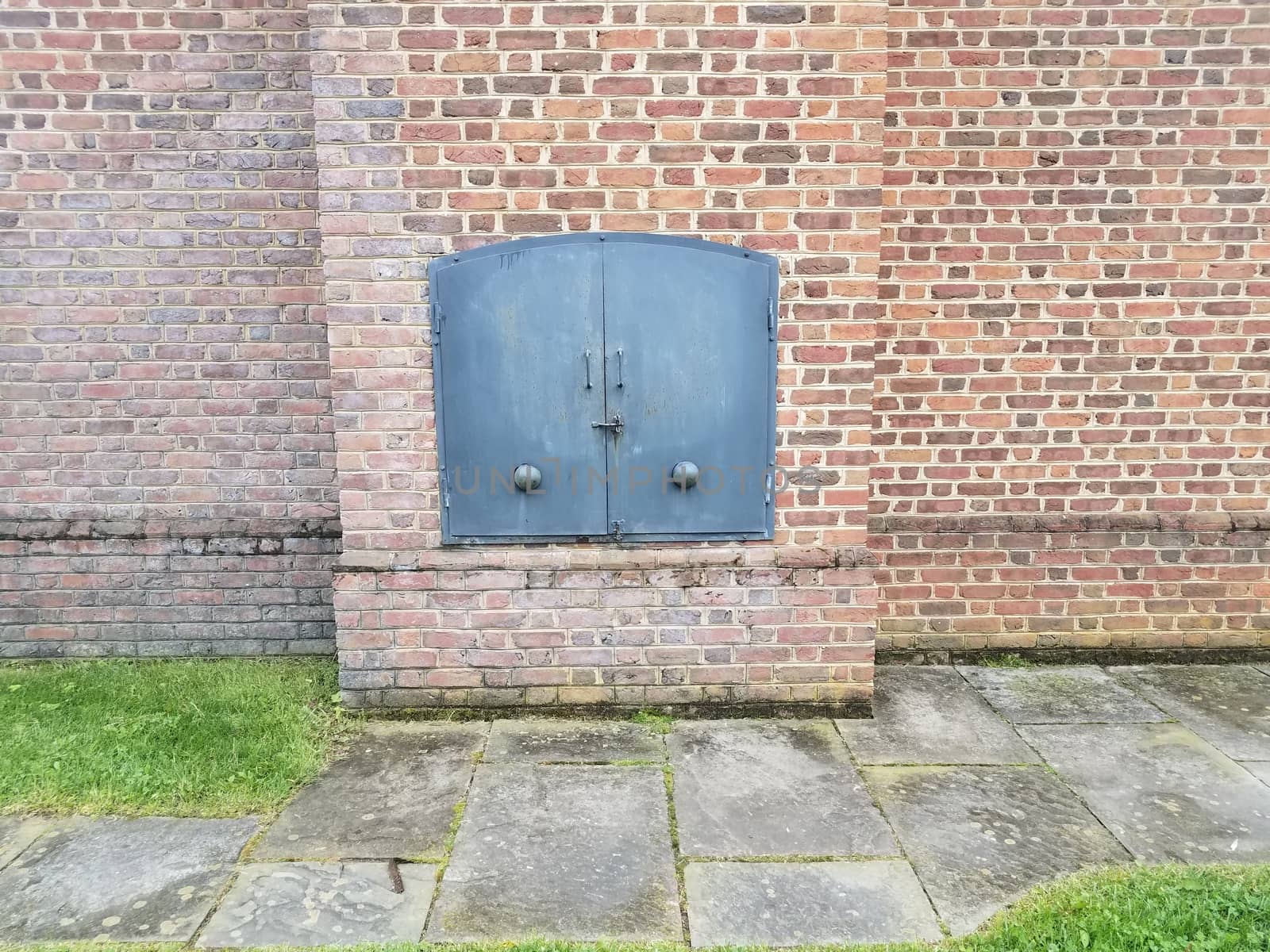 red brick wall and iron metal door by stockphotofan1