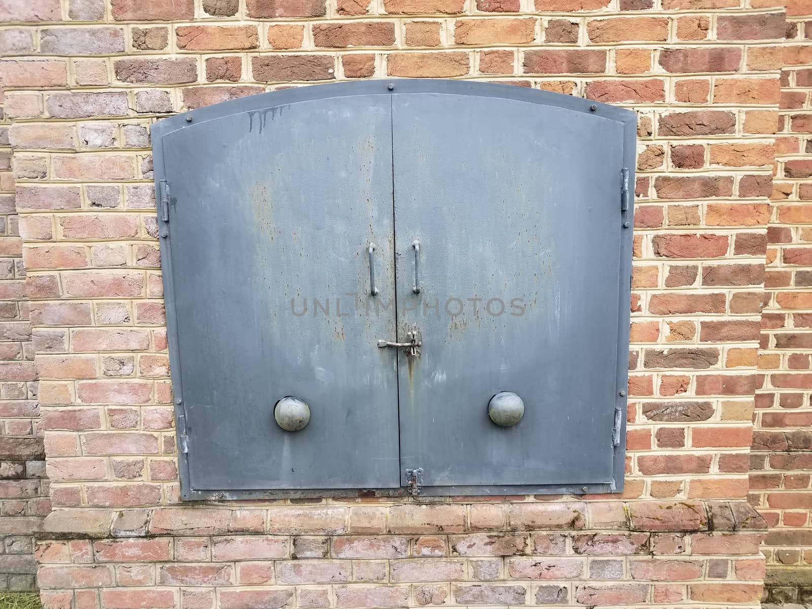 red brick wall and iron metal door by stockphotofan1