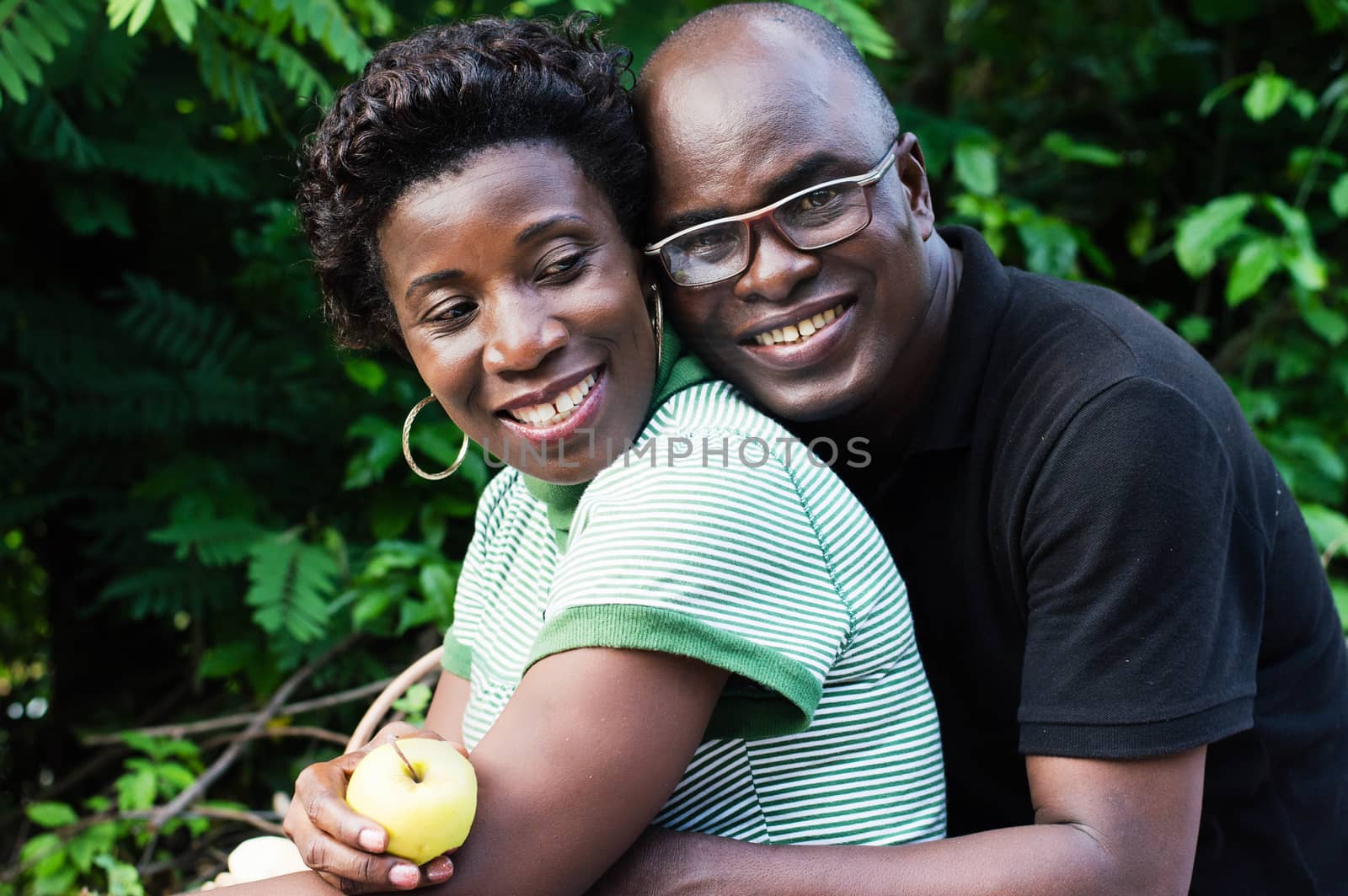 happy young couple hugging sitting in the bush picnic
