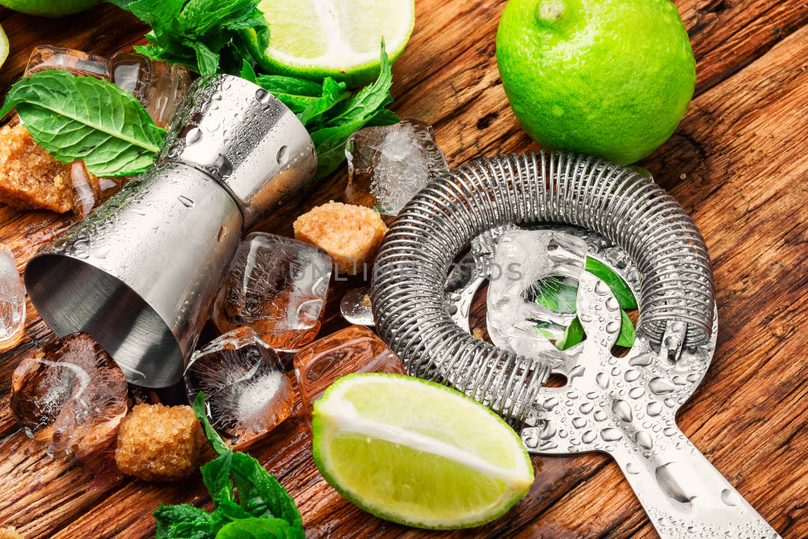 Mint, lime, ice ingredients and bar utensils