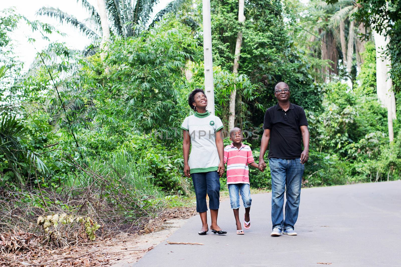this couple in countryside ride with their child in their midst.