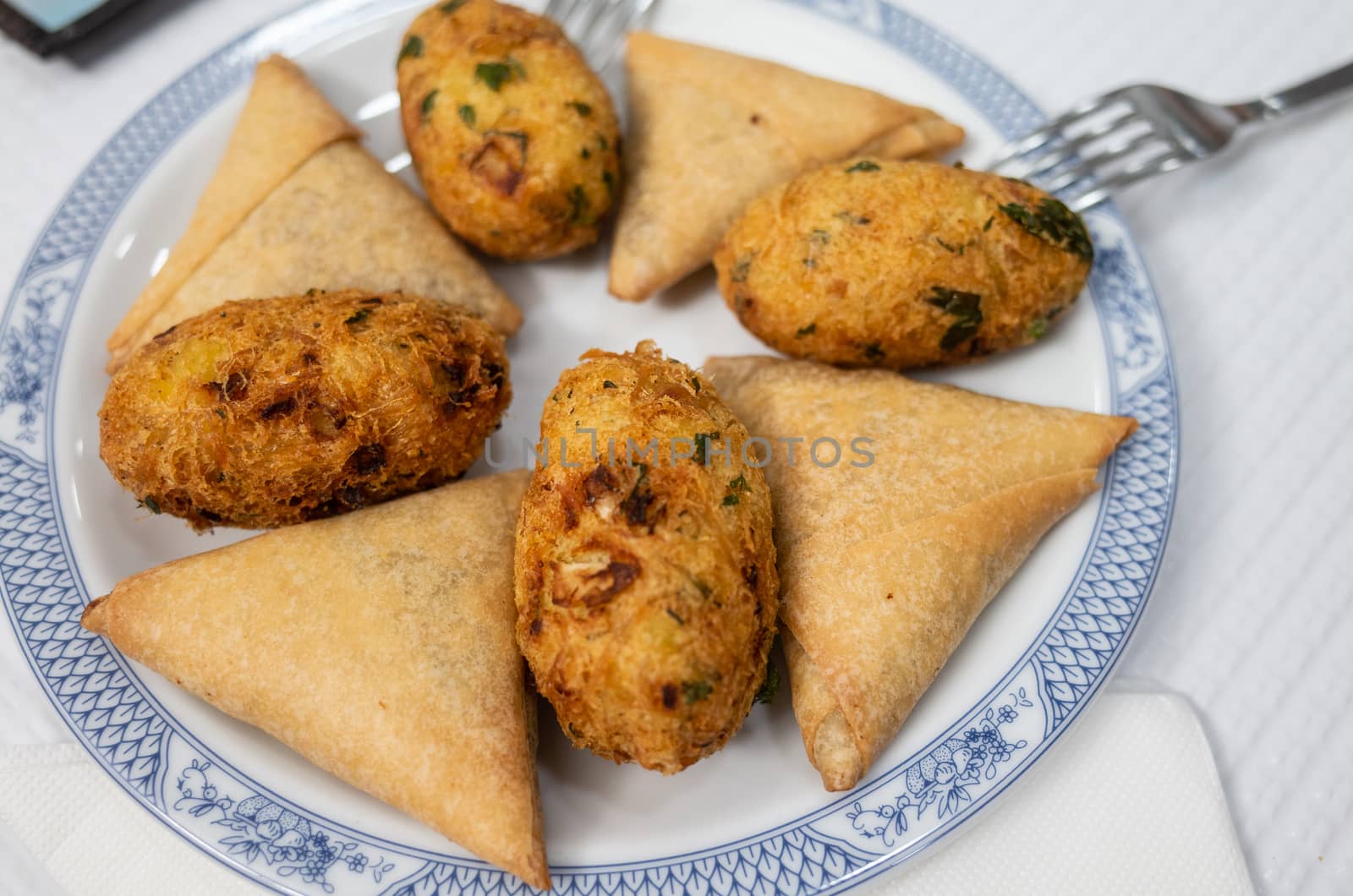 A few traditional Portugese starters served on a nice plate.