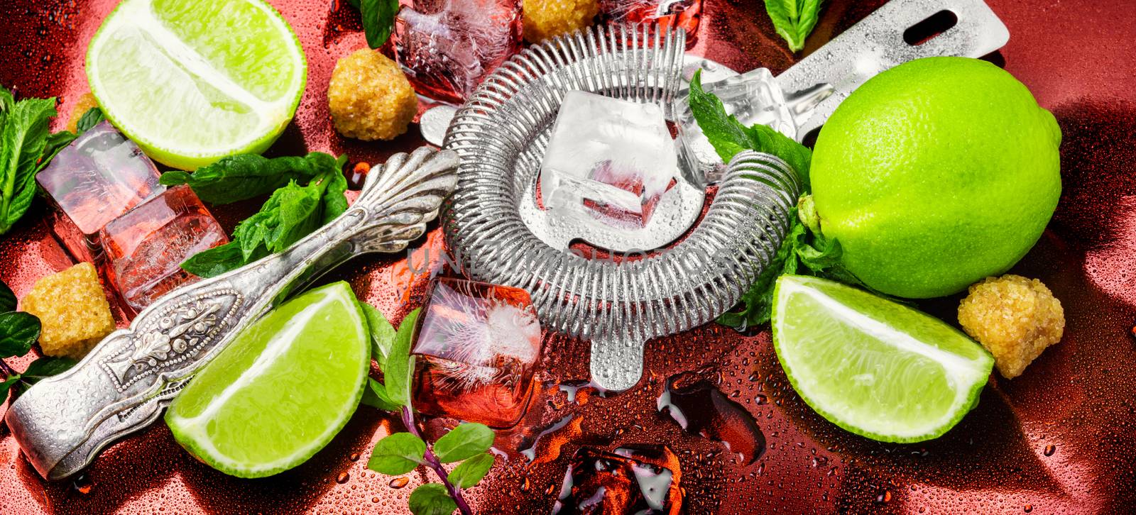 Mint, lime, ice ingredients and bar utensils.Strong alcoholic drinks