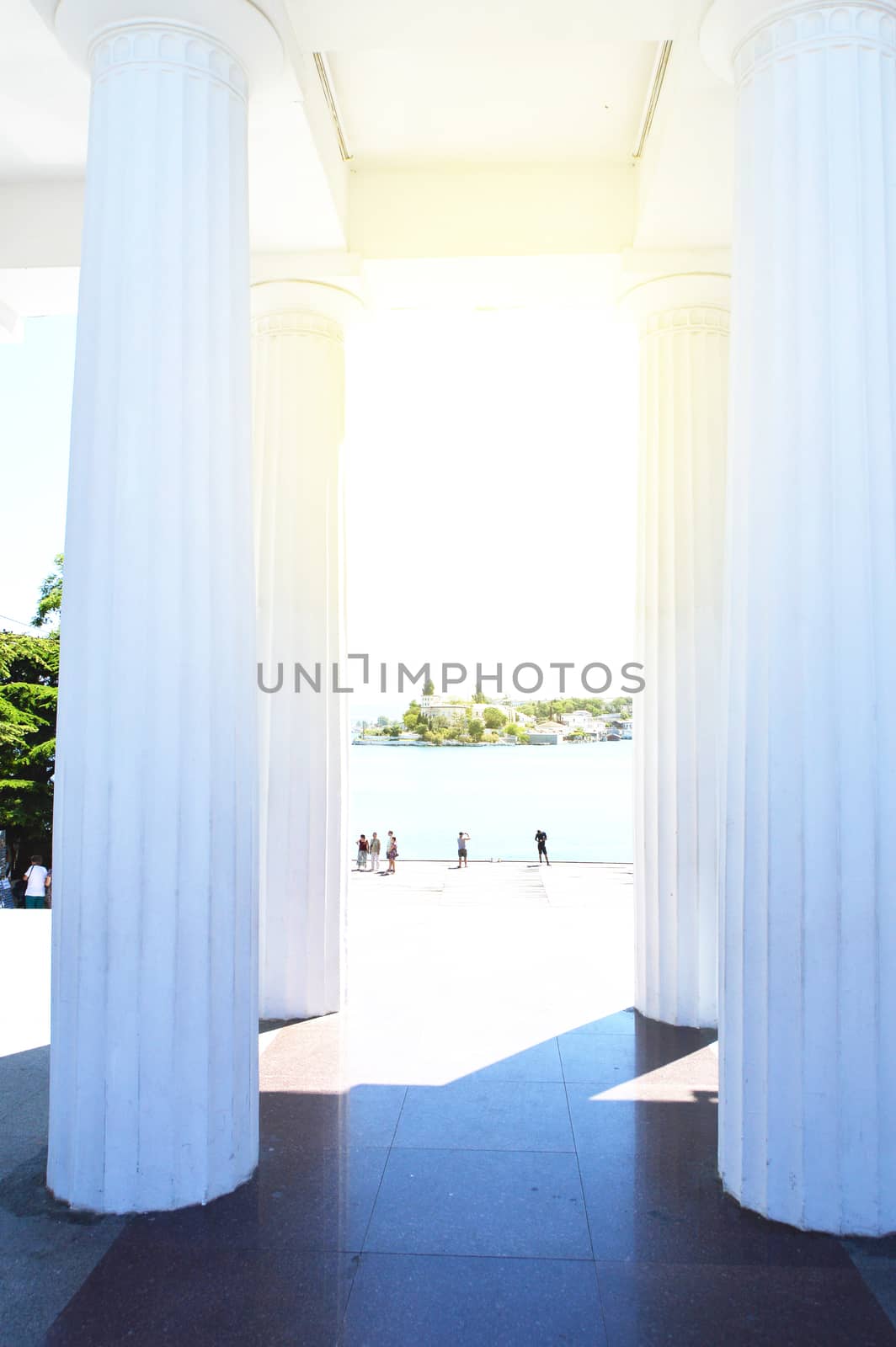 View of the white columns and the sea promenade on a Sunny summer day, resort, tourist attraction.