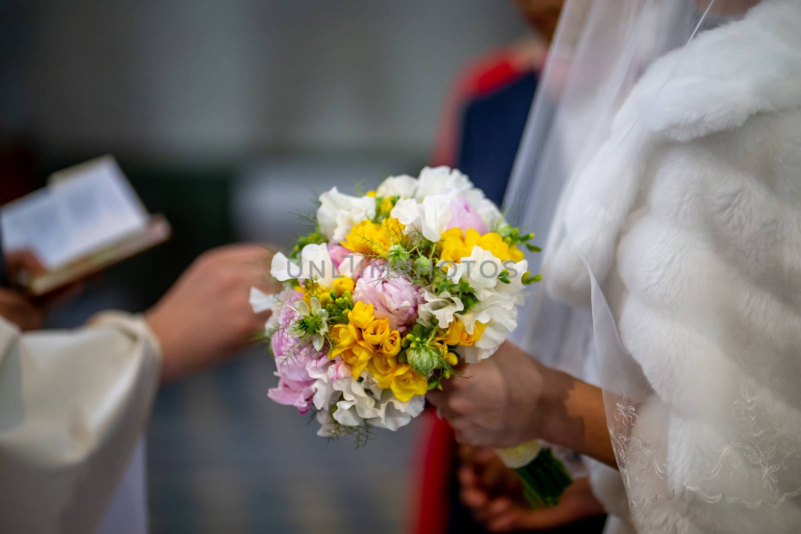Bouquet of flowers in the hand of the bride during the marriage  by fotorobs
