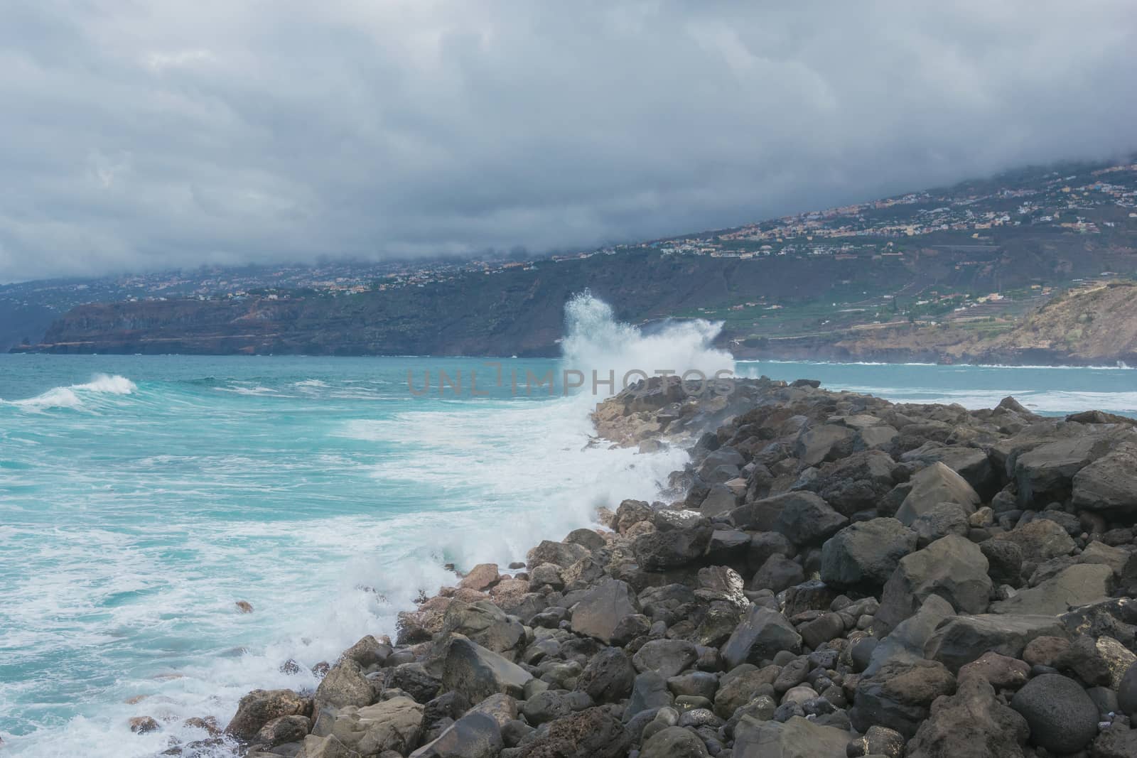 Ocean waves crashing against rocks. landscape on tenerife