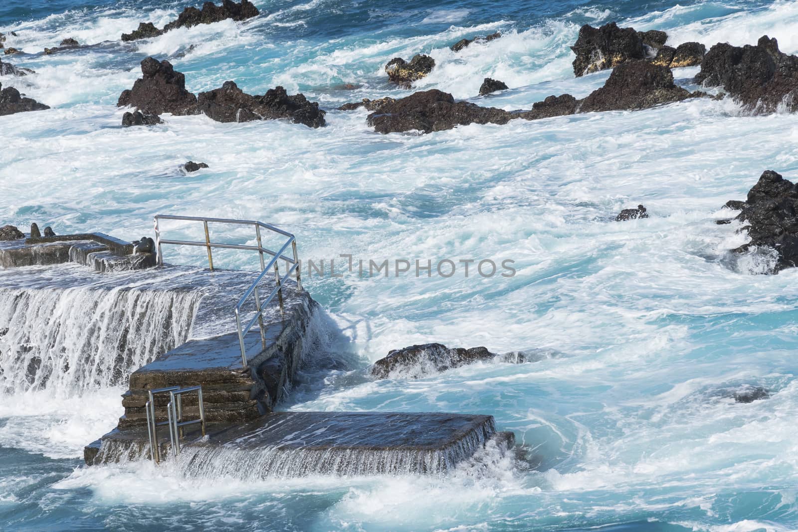 ocean and waves flooding the pier. beautiful water and rocks. beautiful landscape of Canary Islands
