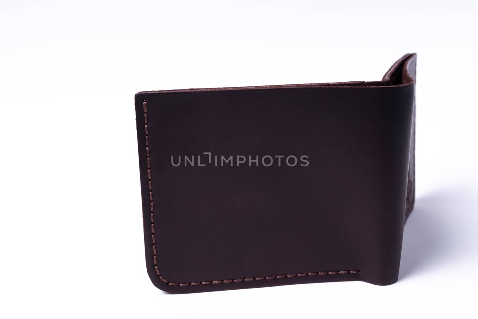 Brown handmade leather man wallet isolated on white background. Wallet is open. Stock photo of luxury businessman accessories.