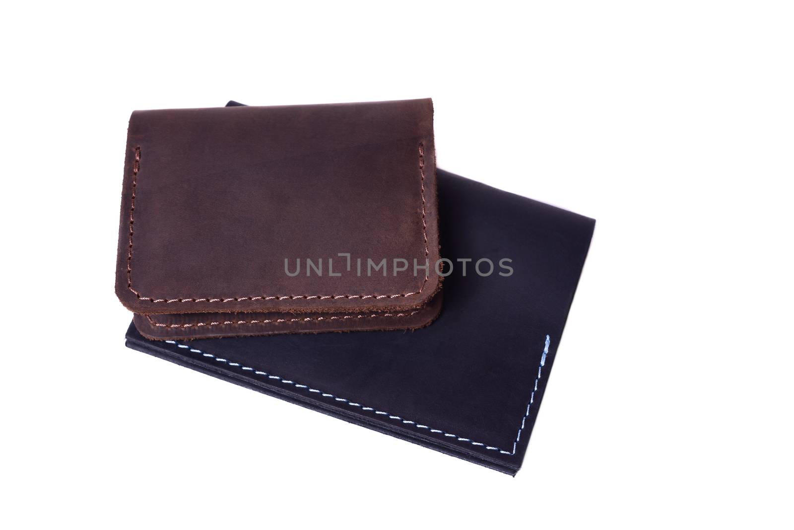 Handmade brown cardholder and black passport cover isolated on w by alexsdriver