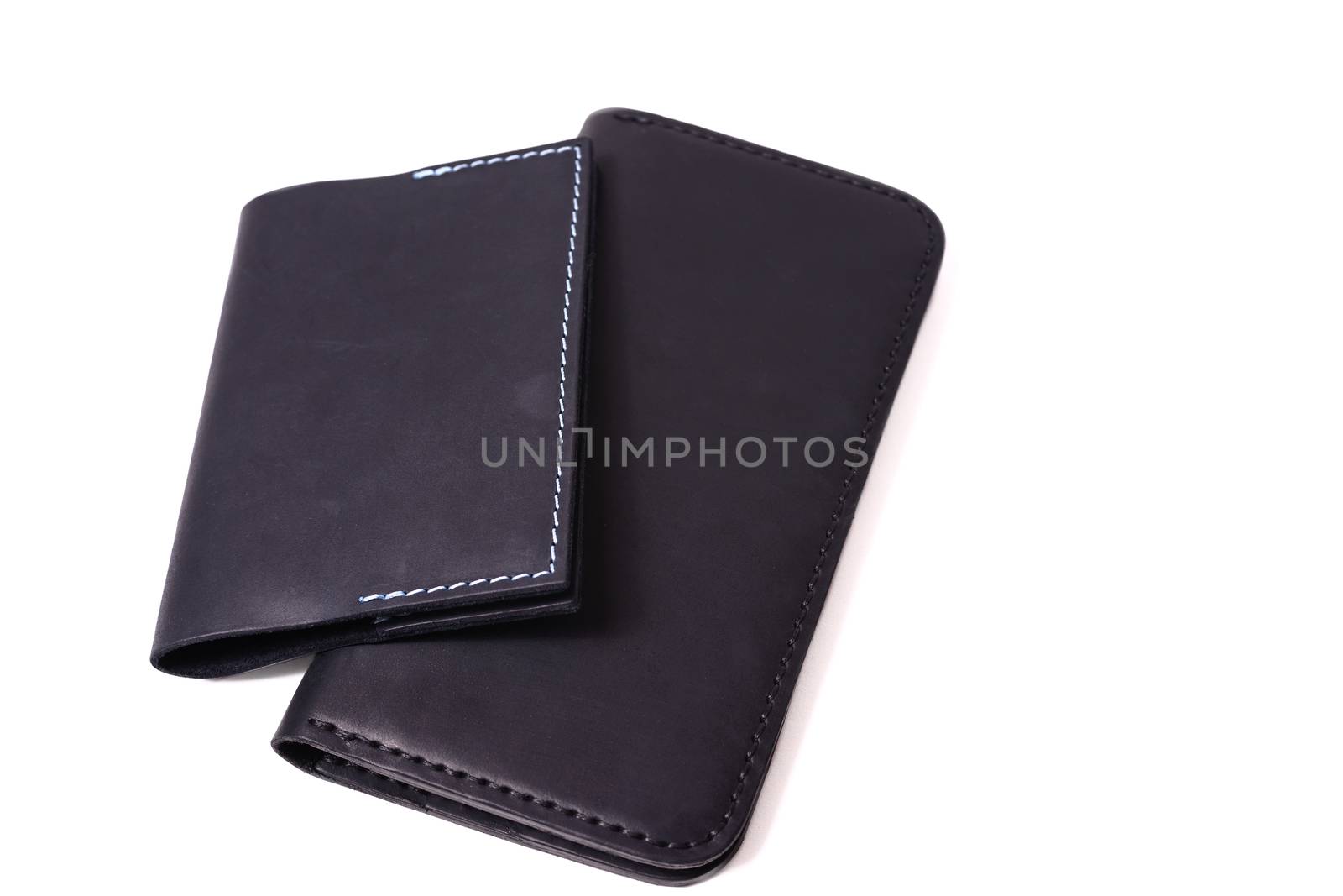 Handmade blue passport cover and black purse isolated on white b by alexsdriver