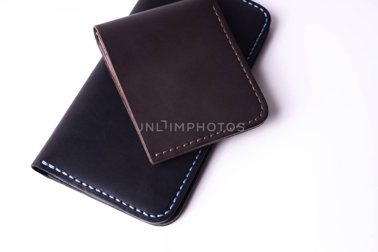 Handmade leather black purse and brown wallet isolated on white  by alexsdriver